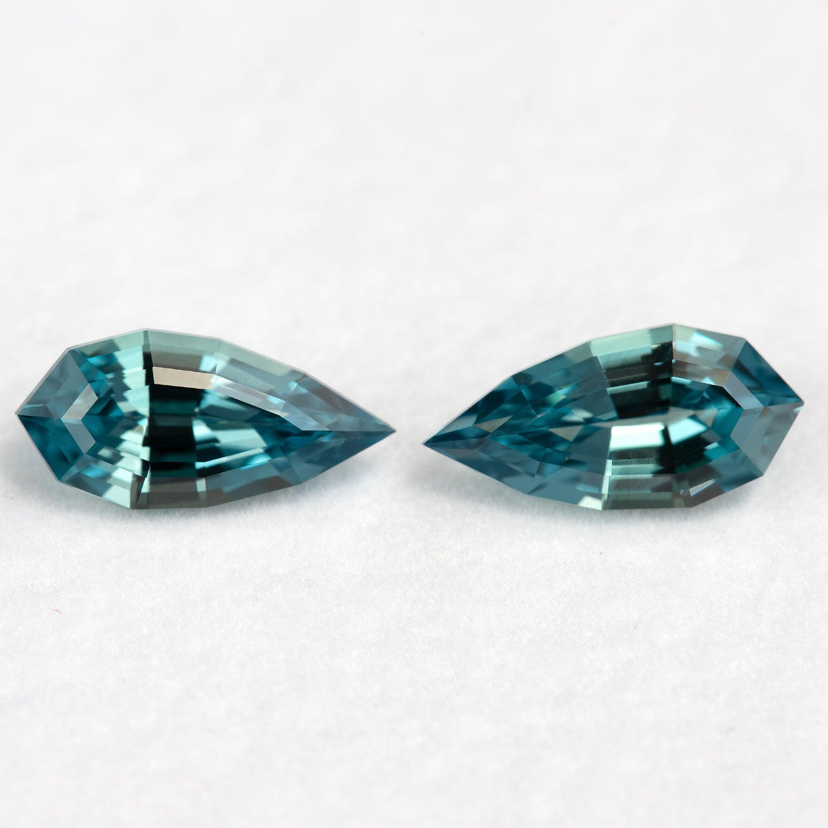 Face-up view of the closely matched BLS114 teal lab-grown sapphire pair.