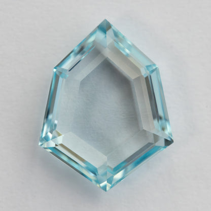 Aquamarine-blue shield-shaped lab-grown sapphire viewed from the pavilion side. View 11.