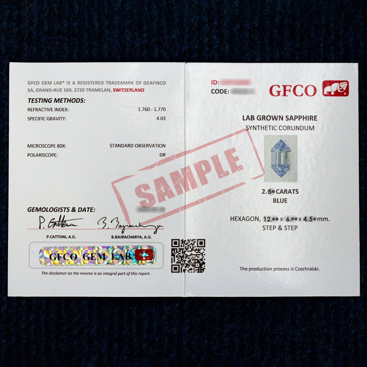 GFCO report photograph marked SAMPLE for the blue lab-grown sapphire production, shown against dark fabric.