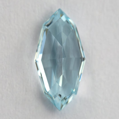 Reverse view of the aquamarine blue / light blue sapphire showing pavilion facets.