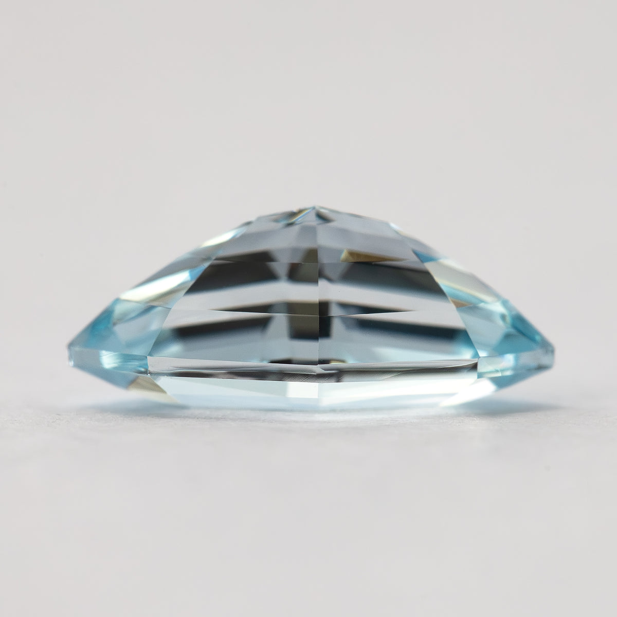 Inverted side profile of the light blue marquise step-cut lab-grown sapphire, with its pavilion above the girdle.