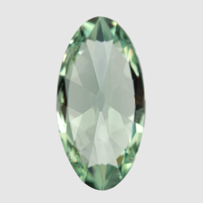Back-facing vertical view of the mint-green lab-grown sapphire, with pale central pavilion reflections.