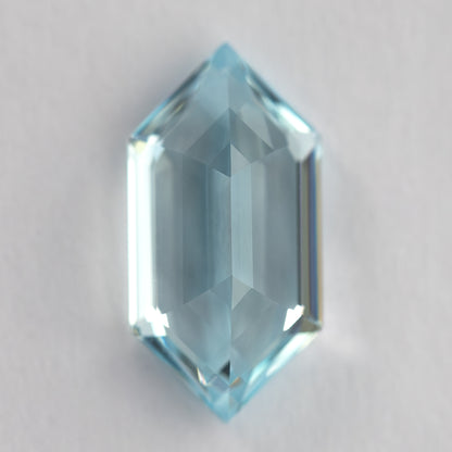 Vertical back-facing view of the aqua-blue lab-grown sapphire, showing broad pavilion reflections.