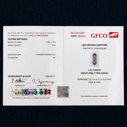 GFCO Gem Lab report photographed open, showing the report details and a gemstone image.