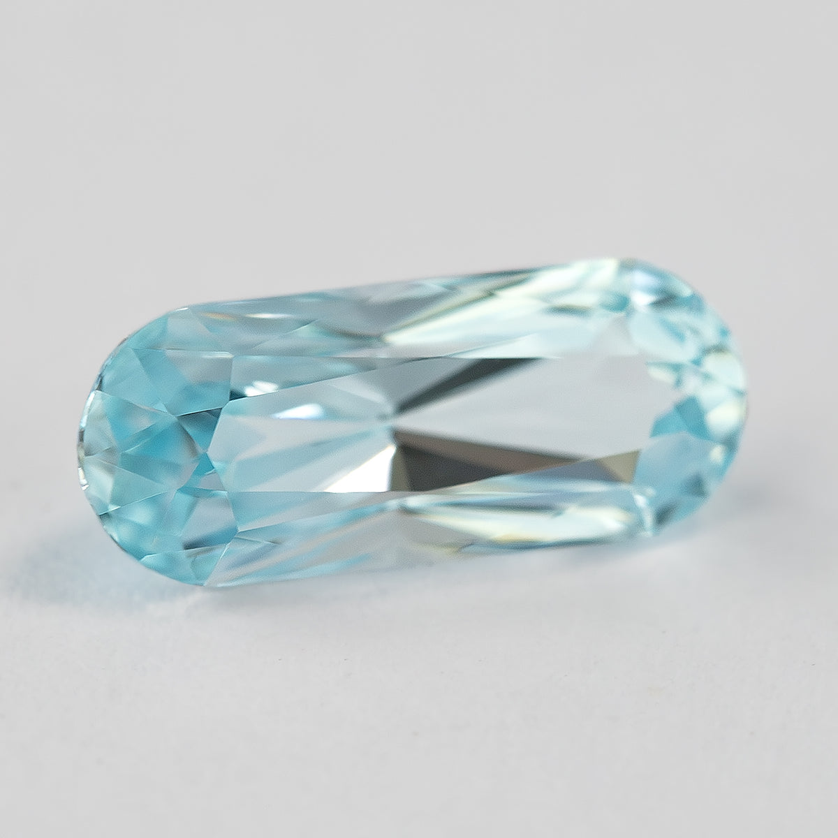 Oblique face-up view of the light blue long-oval sapphire.