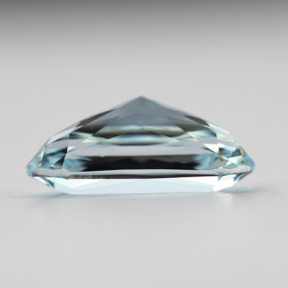 Lower side view of the elongated sapphire, showing its domed profile.