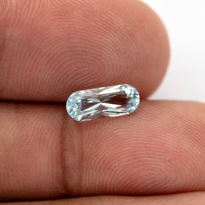 Long-oval sapphire on a fingertip at a slightly different angle.