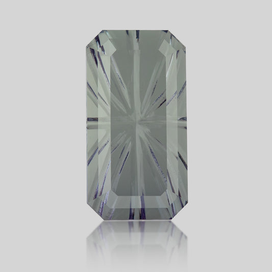 Centered face-up view of an elongated octagonal lab-grown sapphire with a pale green-blue-gray appearance.