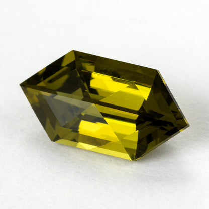 Yellow-green lab-grown sapphire tilted in the opposite direction, revealing a different crown reflection pattern.