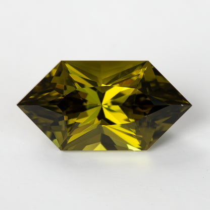 Face-up olive yellow-green hexagonal lab-grown sapphire on a white background.