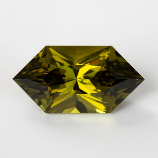 Face-up olive yellow-green hexagonal lab-grown sapphire on a white background.