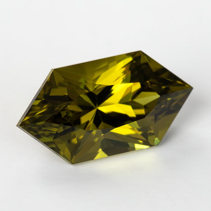 Oblique face-up view of the olive-green lab-grown sapphire showing its depth and angular facets.