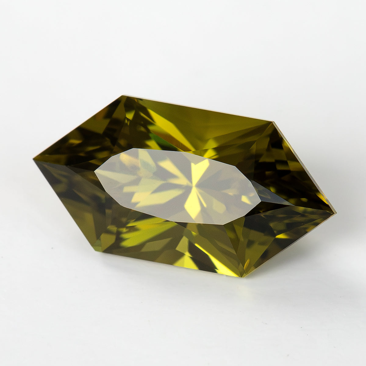Tilted face-up sapphire with a white reflection across the table facet.