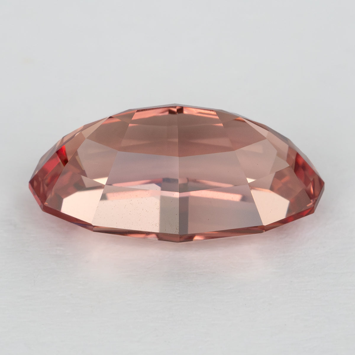Low side view of the lab-grown sapphire showing its profile and facet tiers.