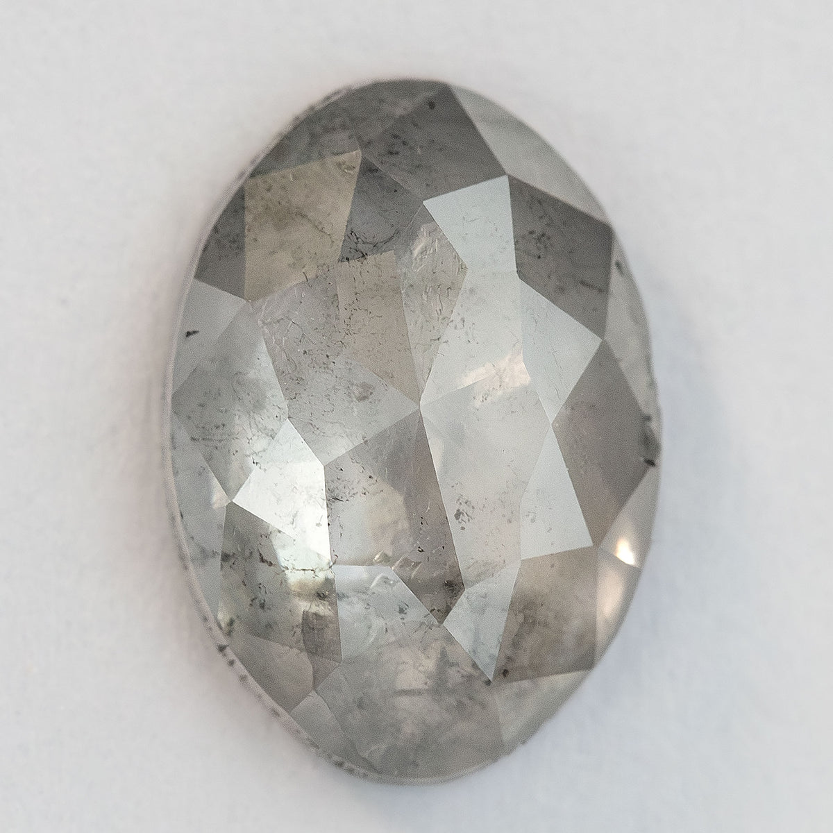 A second upright view of the oval diamond with broad facet reflections.