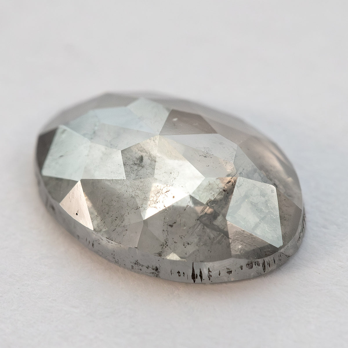 Another low-angle view of the oval diamond and its domed crown facets.