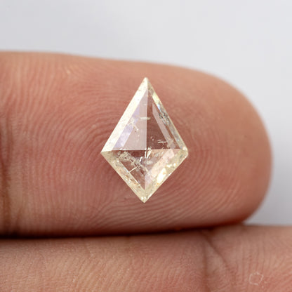 Upright kite diamond on a fingertip, with the pointed outline fully visible.