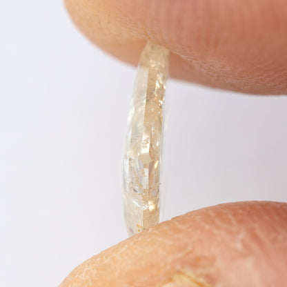 Thin edge-on profile of the kite diamond held between fingertips.