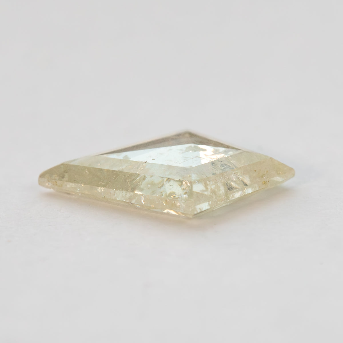 Side profile of the low-domed kite diamond on a pale surface.