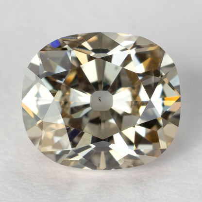 Face-up view of the 0.64 ct Old Mine Cut natural diamond, showing its facet pattern and large culet on a light background.