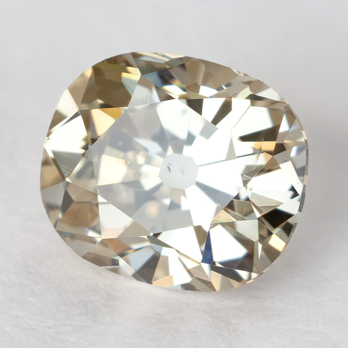 Tilted face-up view of the loose diamond, showing light reflections across the crown facets.