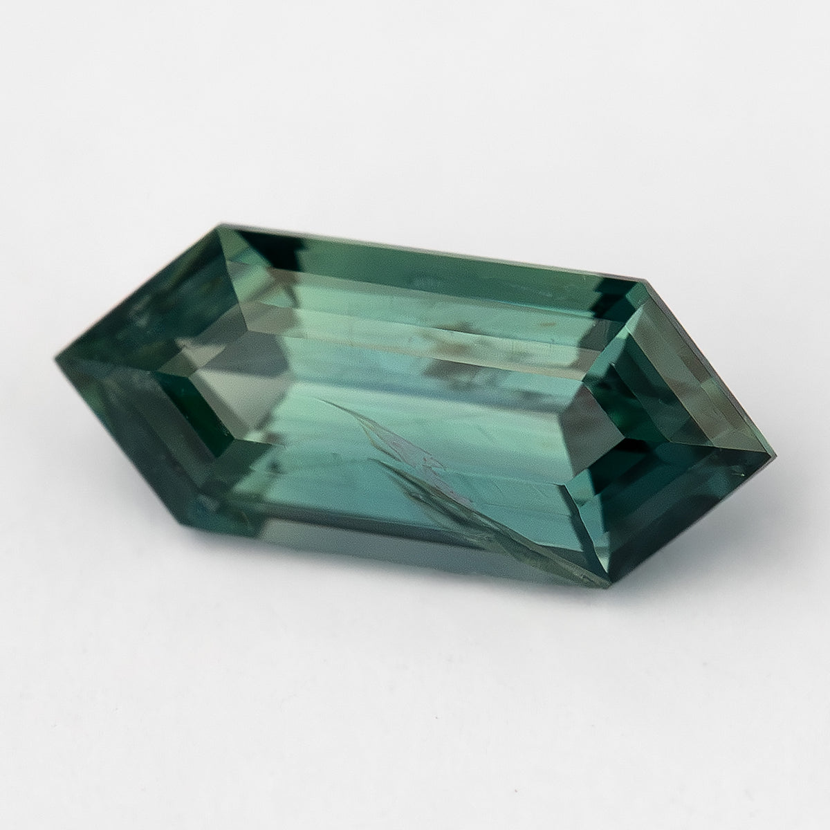 Alternate daylight view of available #3 BNS153 deep teal sapphire.