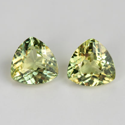 Alternative close-up of both trillion sapphires, showing individual differences in reflected yellow and green tones.