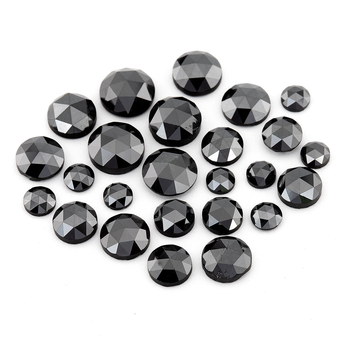 Group of black round rose-cut diamonds of mixed sizes on a white background, showing triangular crown facets.