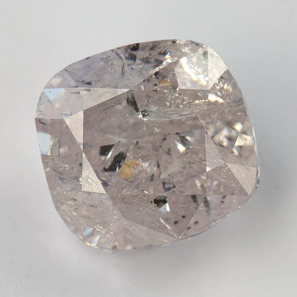 Alternate face-up macro of the natural light pink cushion diamond with heavy inclusions and modified brilliant facets.