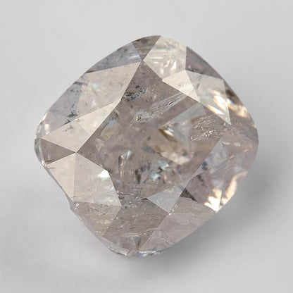 Angled face-up view of the light pink cushion modified brilliant diamond and its softly rounded square outline.
