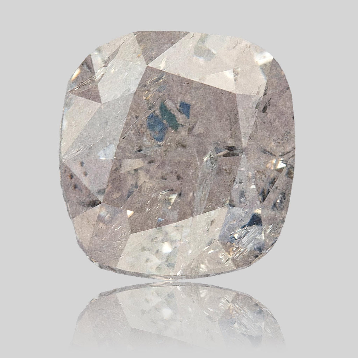 Upright macro view of the natural light pink cushion diamond showing its modified brilliant facet pattern.