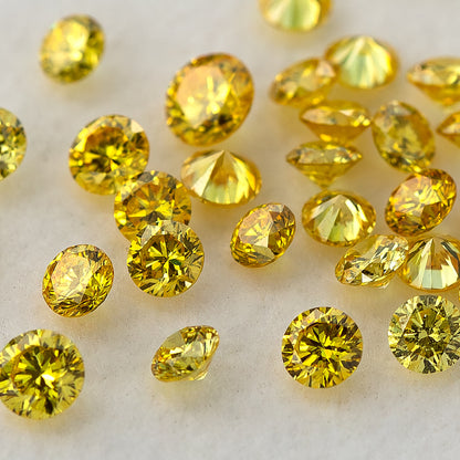 Closer tilted cluster of yellow diamonds showing crowns, girdles and pavilions.