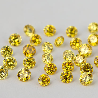 Low face-up angle across yellow round diamonds, with the nearest facets in focus.