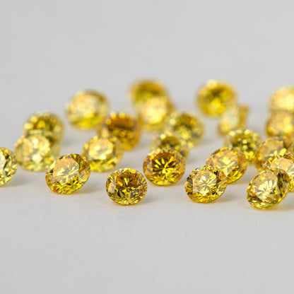 Near side-level view of loose yellow diamonds with crowns and pavilions visible.