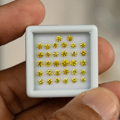 Close front view of a white yellow-diamond tray held by fingers.