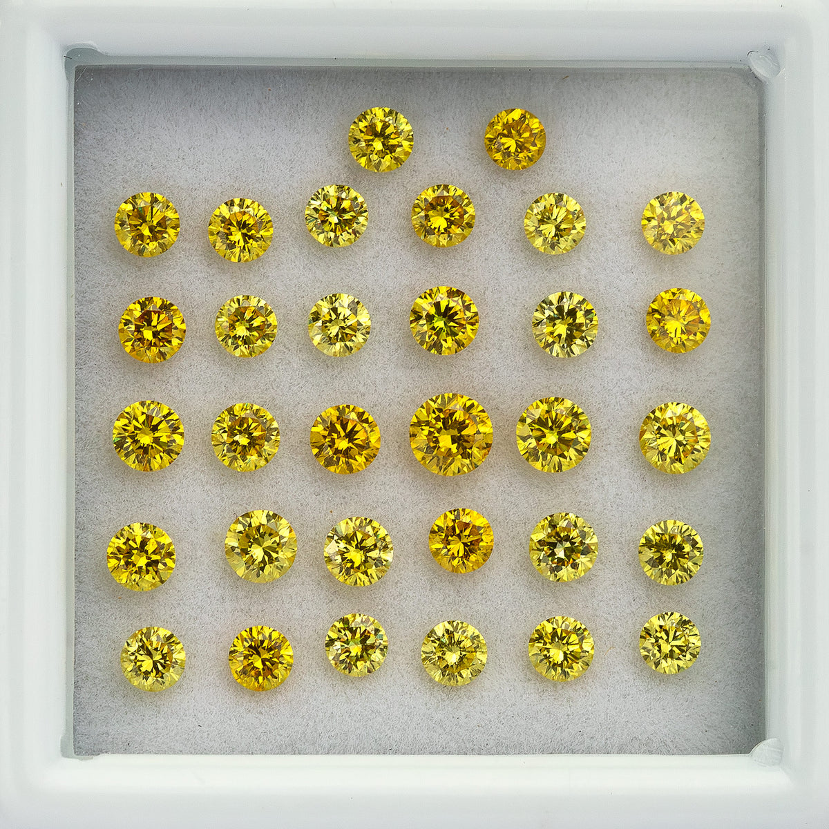 Close overhead view of yellow diamond rows inside the white tray.