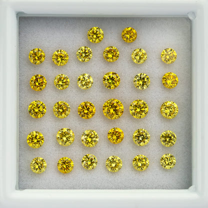 Close overhead view of yellow diamond rows inside the white tray.