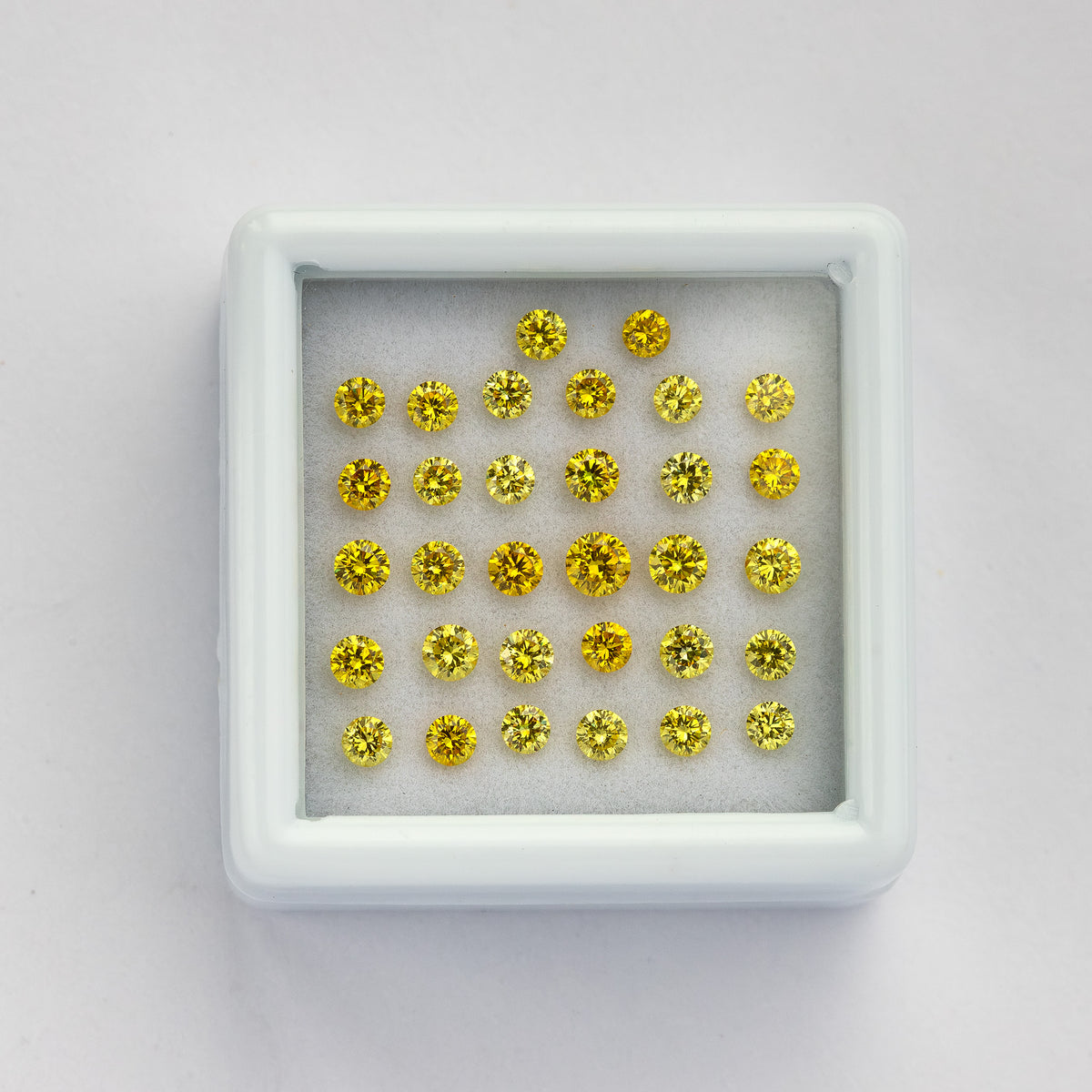White yellow-diamond tray at a slight angle on a pale surface.