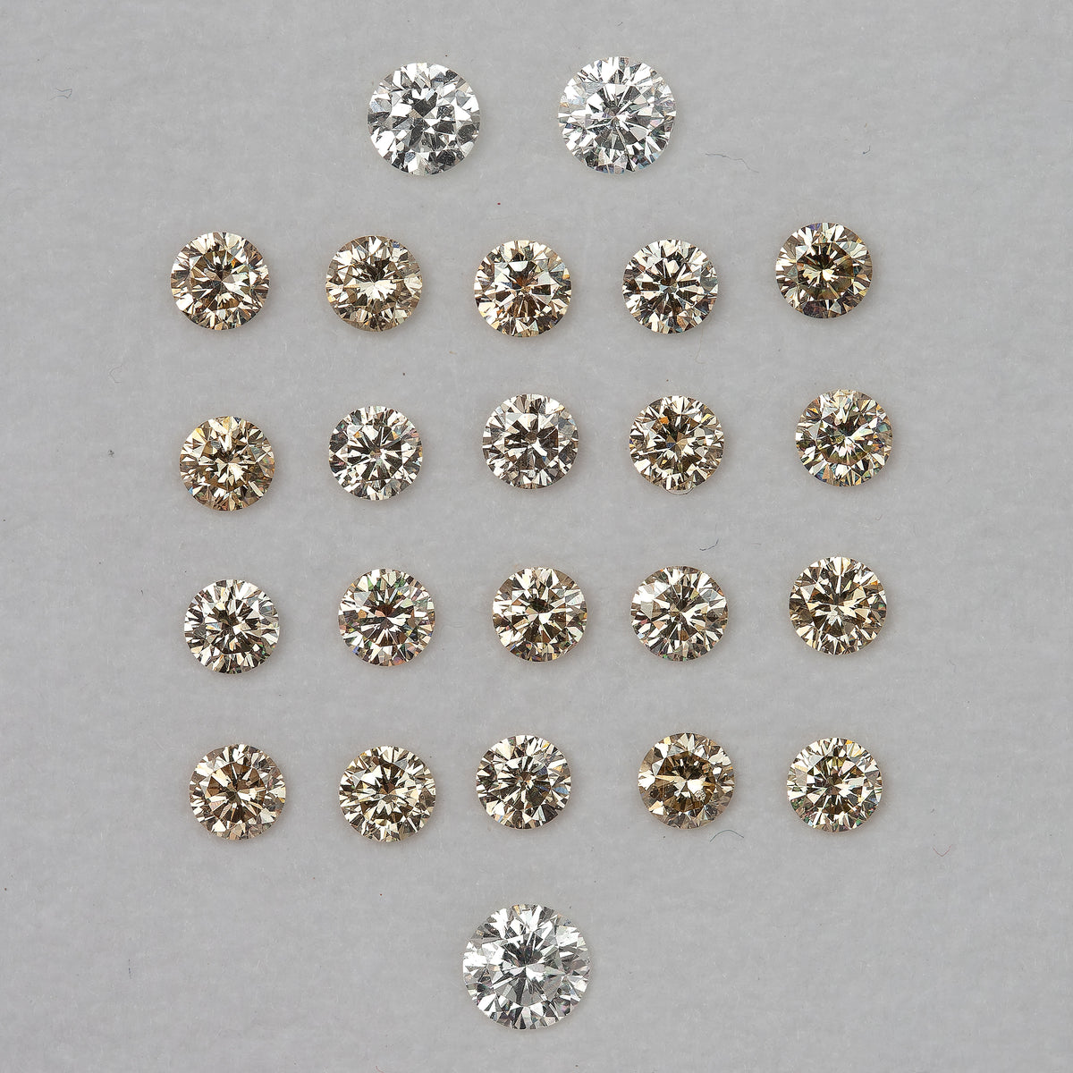 Representative 2.5mm champagne diamond melee with white comparison diamonds that are not included.