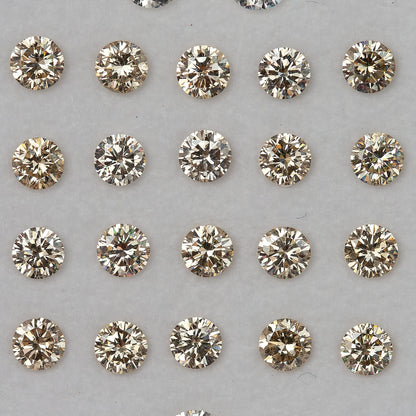 Representative 2.5mm natural champagne round diamond melee arranged face up; other listing sizes are not shown.