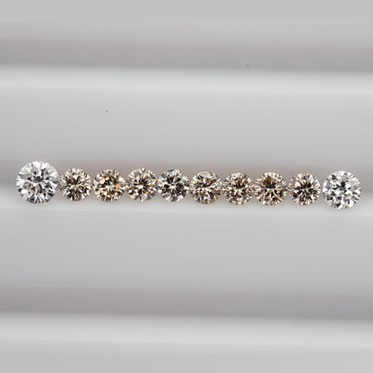 Straight row of representative 2.5mm round champagne diamonds showing calibrated diameter and sparkle.