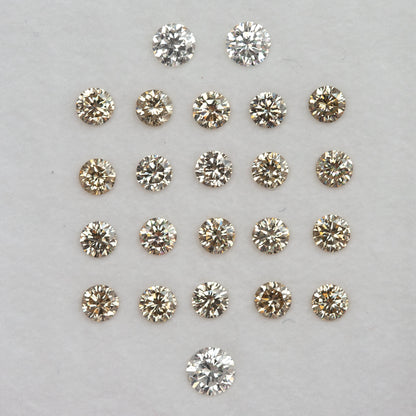 Representative champagne diamond melee arranged on a pale tray; selected pack only is supplied.