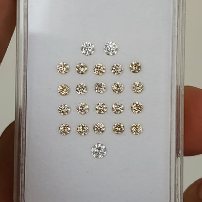 Representative 2.5mm champagne round diamonds showing natural variation in warm tone and reflections.
