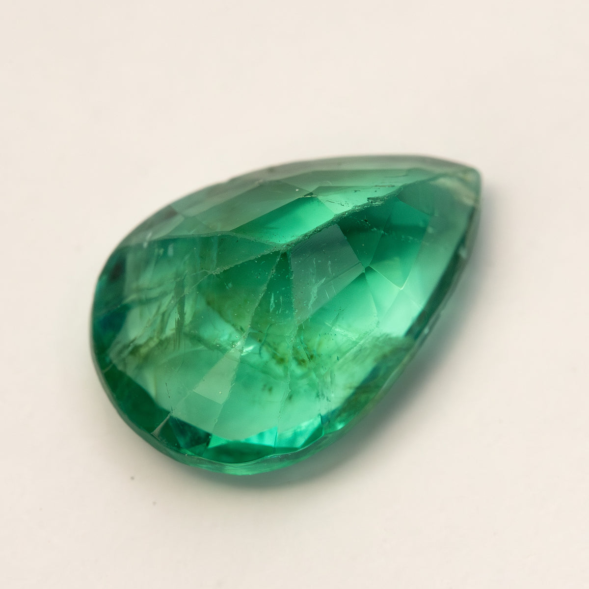 Angled side view of pear emerald showing its depth and internal features.