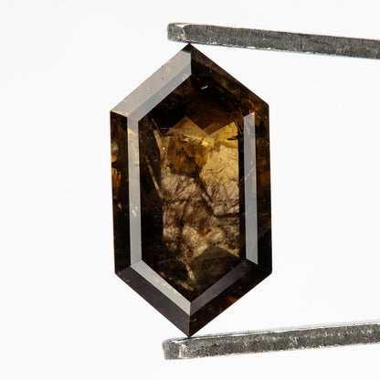 Opposite faceted face of the exact dark brown diamond, showing its geometric facet arrangement and natural inclusion pattern.
