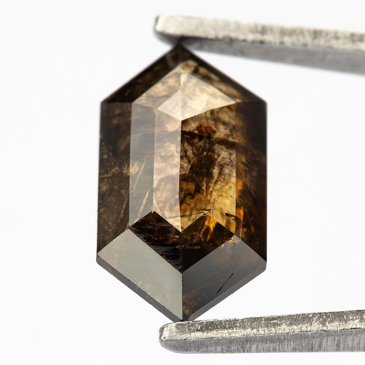 Detailed close-up of one face of the Dutch marquise diamond, showing angular facets and golden-brown reflections.