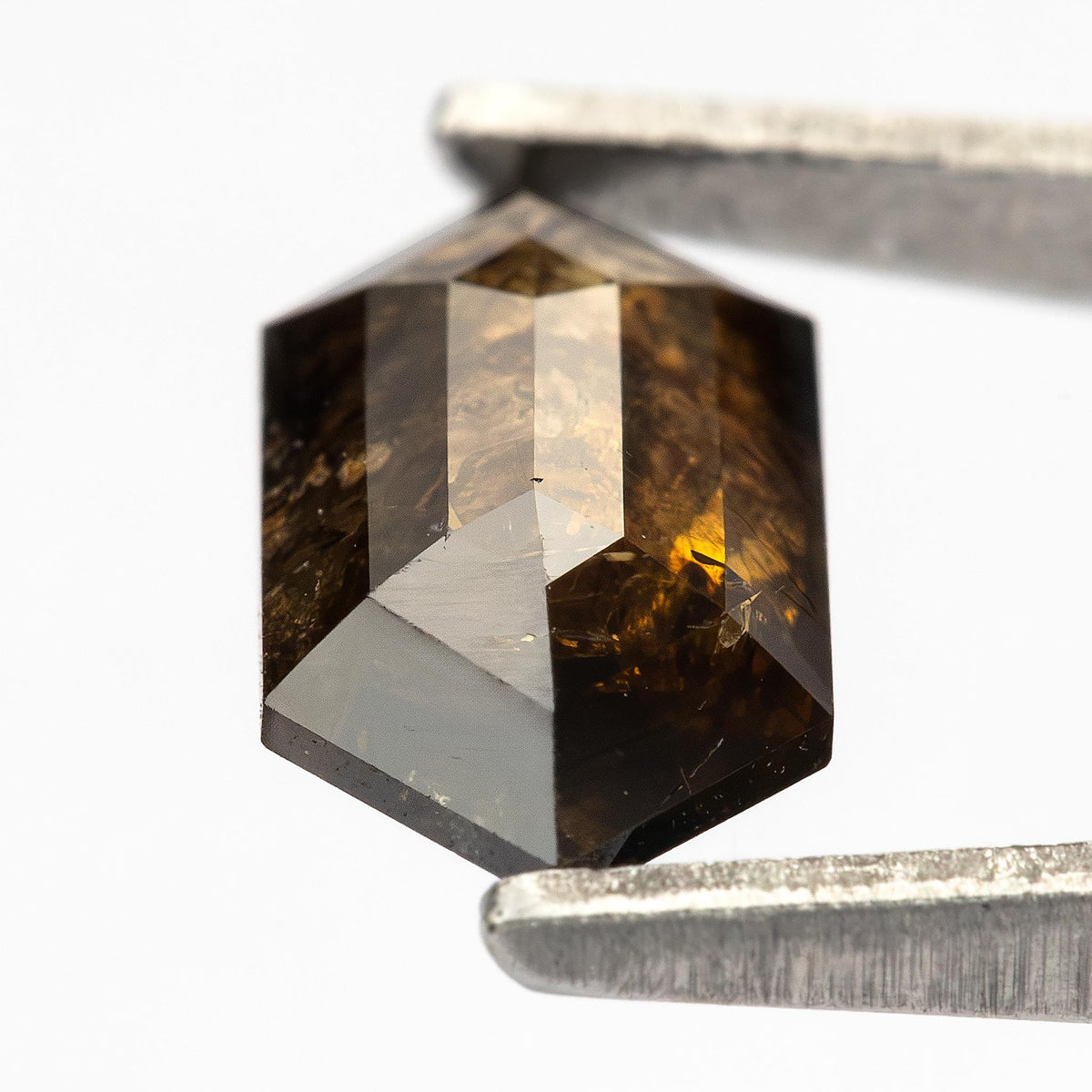Detailed opposite-face view of the double-sided faceted diamond, showing dark reflections and visible inclusions.