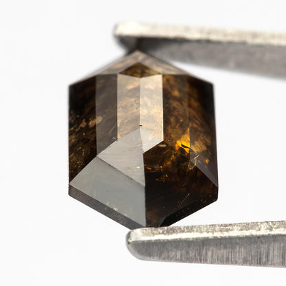 Detailed opposite-face view of the double-sided faceted diamond, showing dark reflections and visible inclusions.
