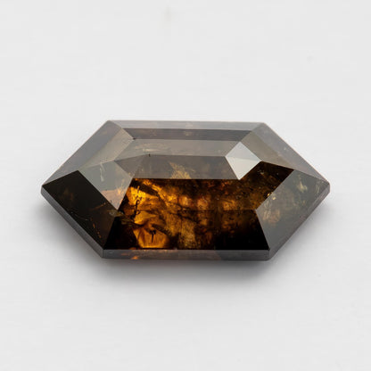 Low-angle view of the dark brown Dutch marquise diamond, showing its profile, geometric faceting and warm reflections.