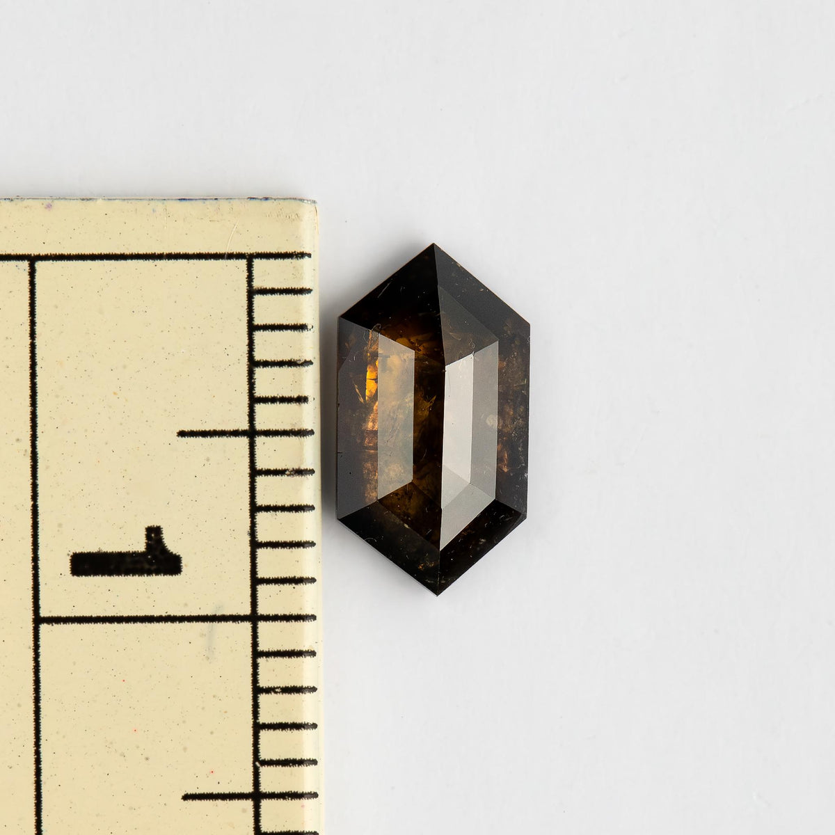 Dutch marquise diamond beside a millimeter ruler, showing its approximately 9.80 mm length and elongated proportions.